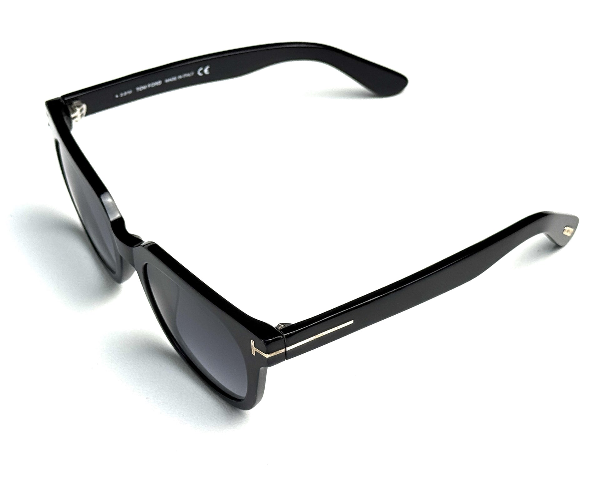 Black sunglasses with gold accents on a white background